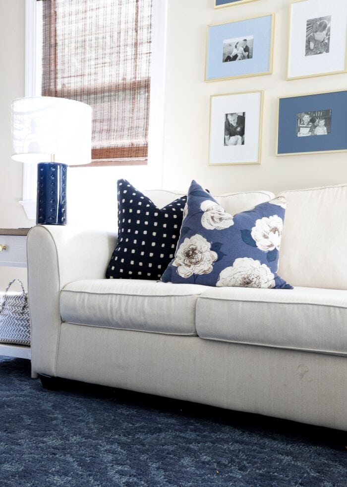 White couch with blue wool rug