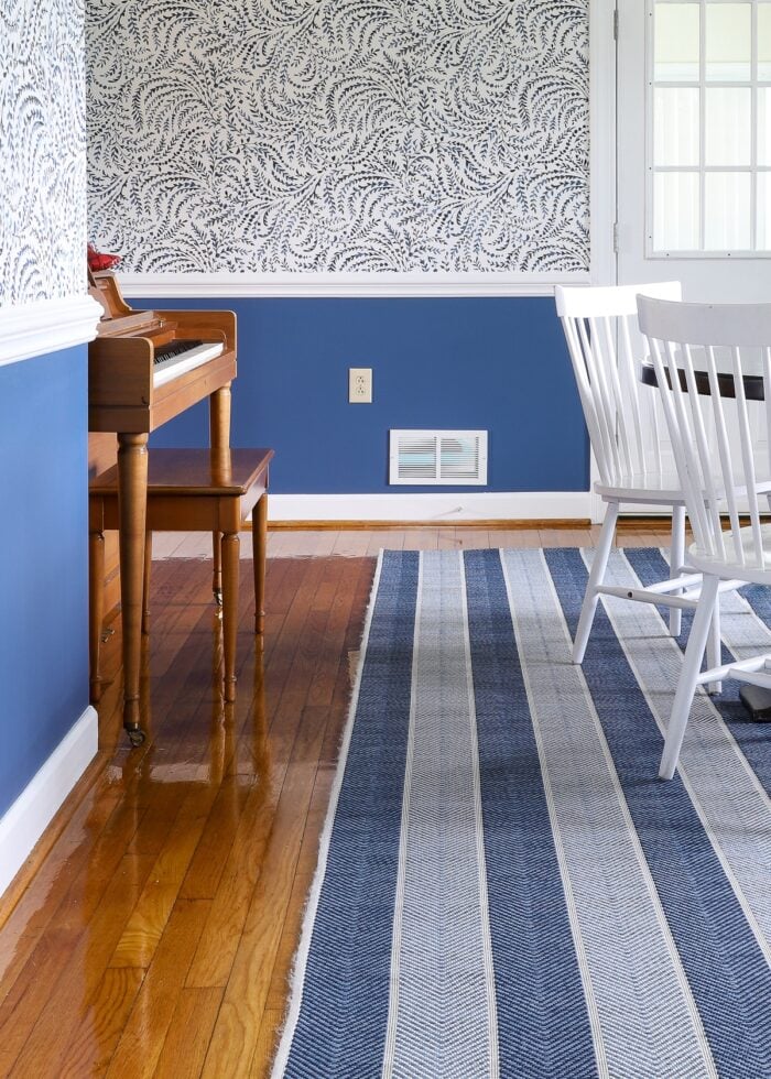 Two-toned blue striped rug on pine floors