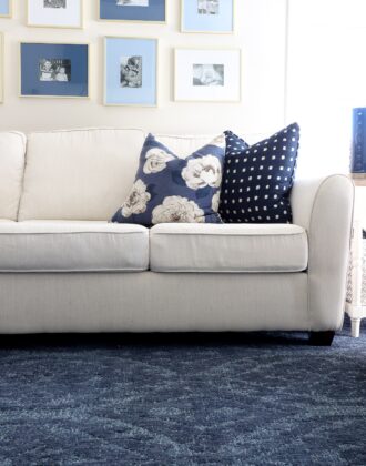 White couch with blue wool rug