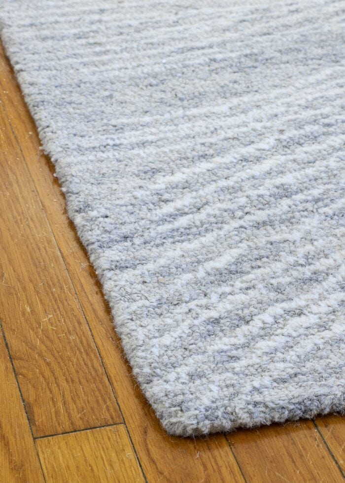 Closeup of grey wool tufted loop rug