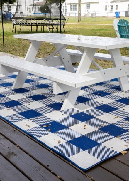 Buffalo Plaid Outdoor Rug (8x10') from Target under a white picnic table