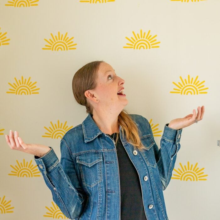 Megan in front of sunshine wall