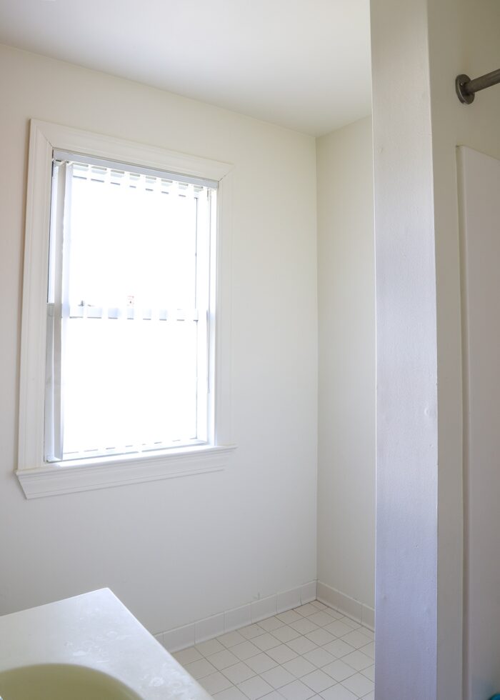 Bathroom corner with all white walls and tile
