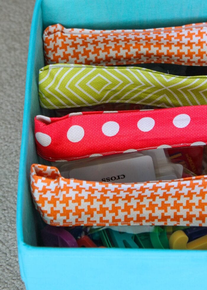 See-through Velcro pouches as small toy storage inside a bigger bin