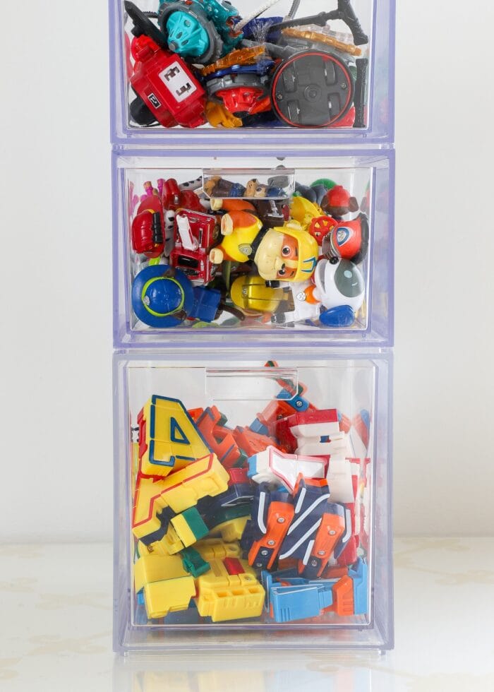 Stacking plastic drawers holding small toys