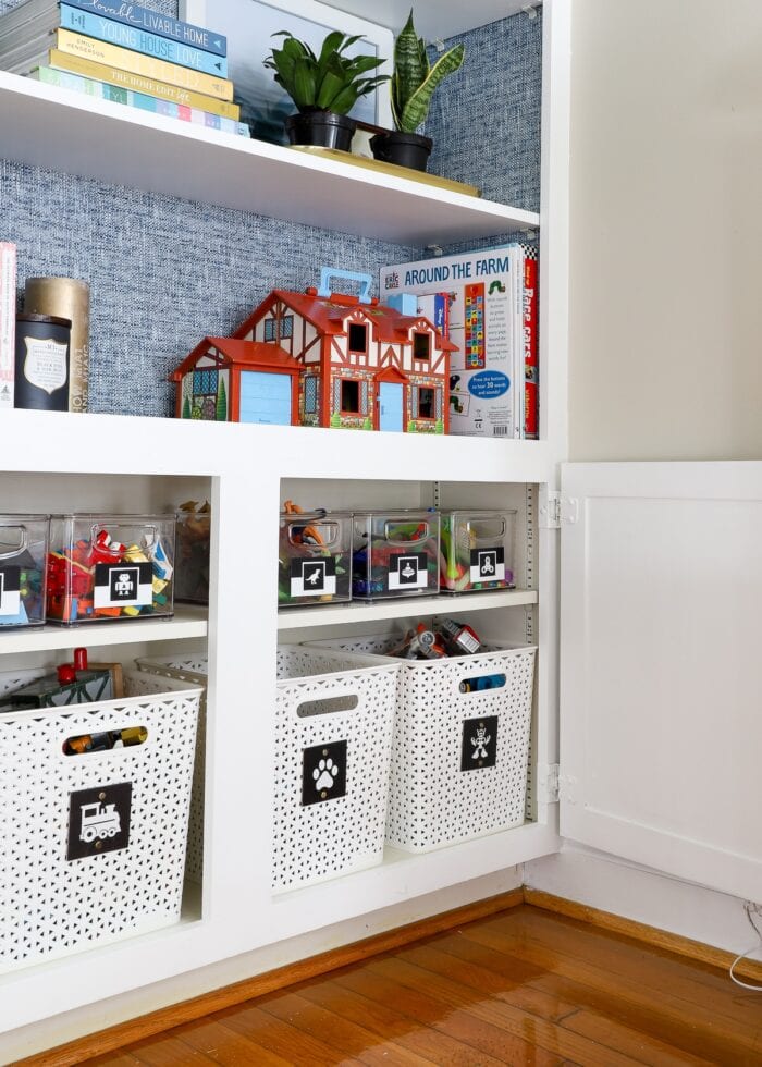 Clear acrylic bins on white shelves as small toy storage