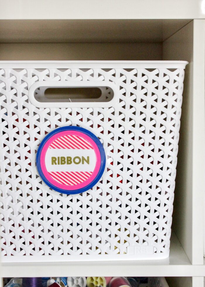 Pink and blue labels made with Cricut Pens on white basket