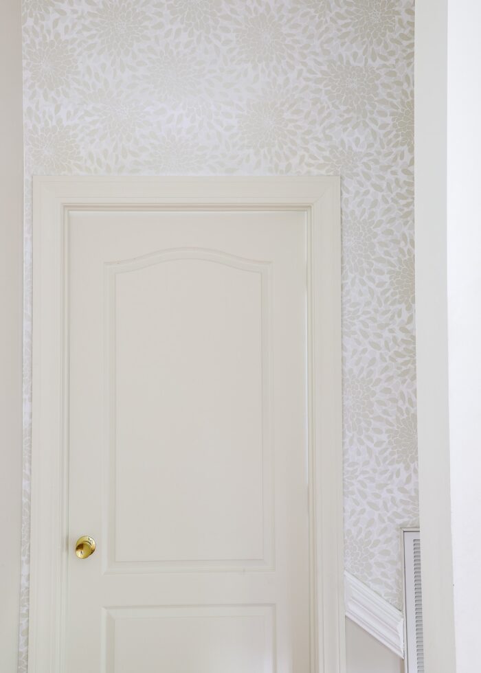 Toss the Bouquet peel and stick wallpaper surrounding a white door