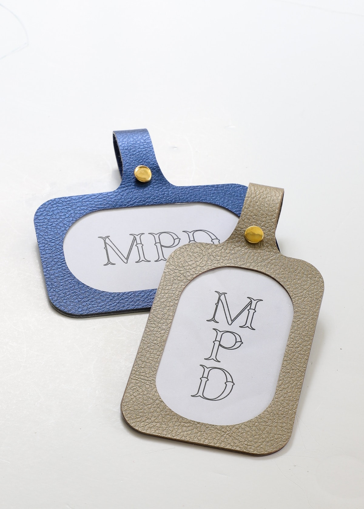 Blue and gold luggage tag labels with monograms