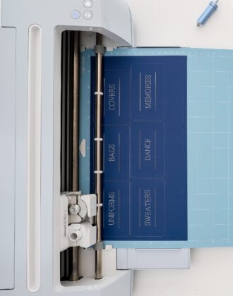 Cricut Maker 3 loaded with blue paper labels