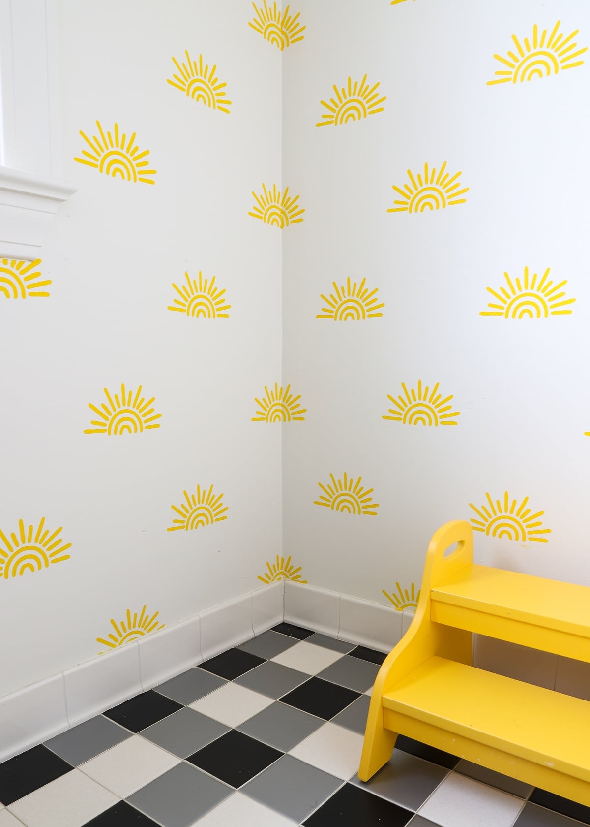 Black and grey floor stickers in a bathroom with sunshines on the wall