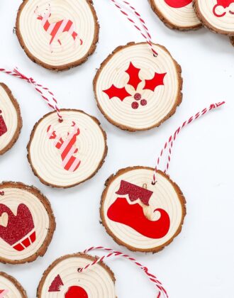 Wood slice ornaments decorated with red Cricut iron-on vinyl