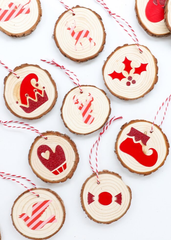 Wood slice ornaments decorated with red Cricut iron-on vinyl