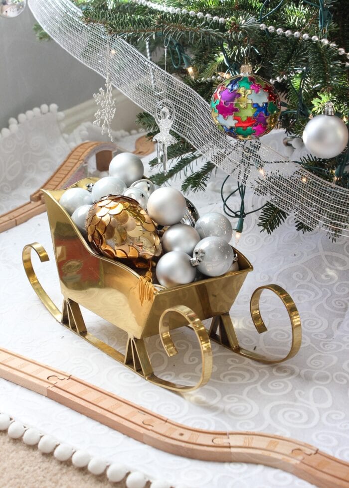 Gold sleigh filled with silver and gold ornaments