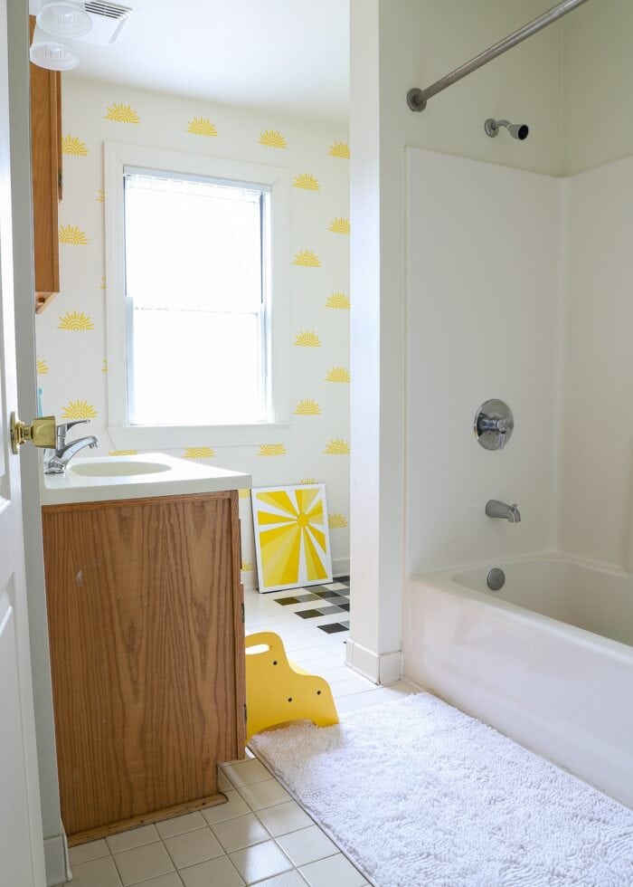 White bathroom with yellow sunshines on the wall