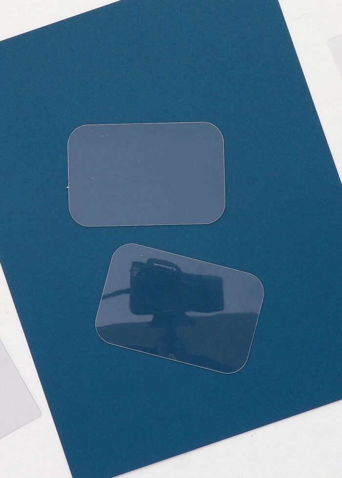 Clear plastic rectangles on a blue piece of paper