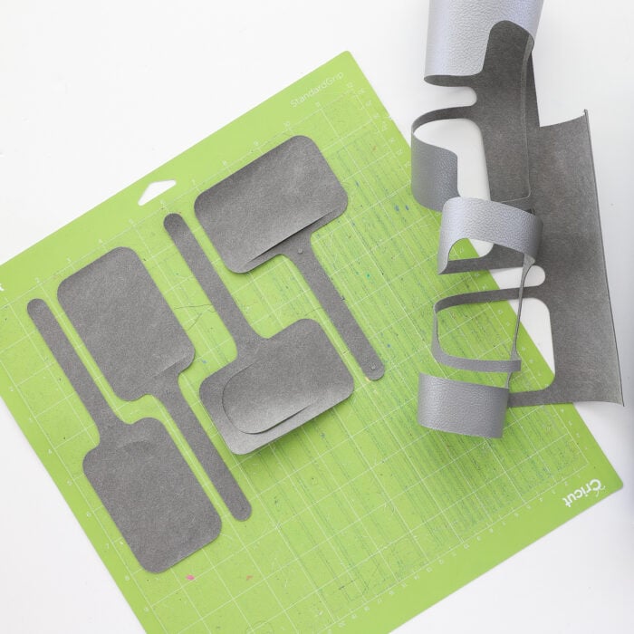 Cut pieces of luggage tag on a green StandardGrip Cutting Mat