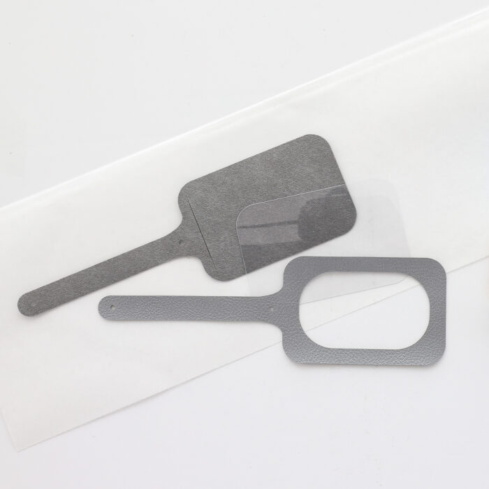 Luggage tag pieces on a white table