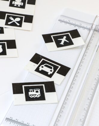 Paper trimmer shown with black and white picture toy bin labels