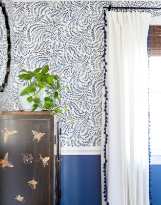Blue and white wallpaper on the wall in a formal dining room