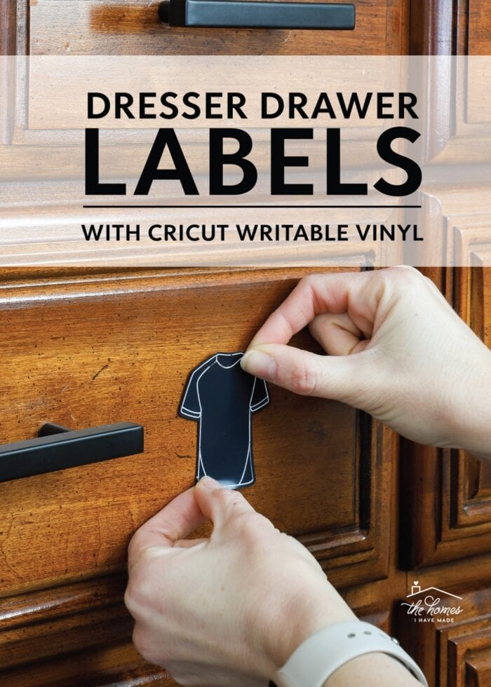 Hands placing a dresser drawer label onto a brown dresser