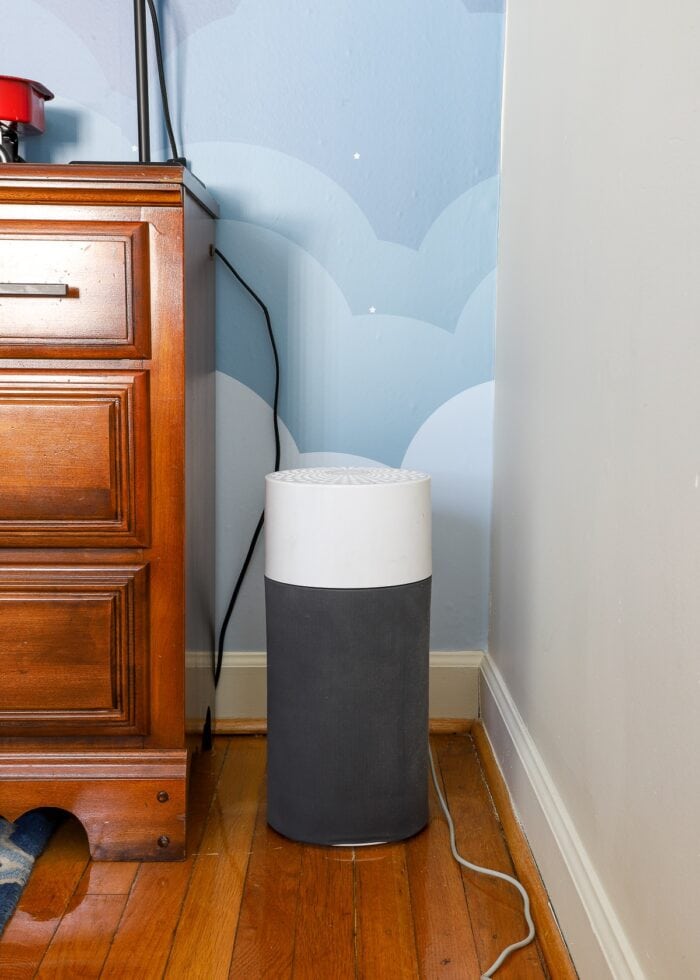 Air purifier in corner of bedroom