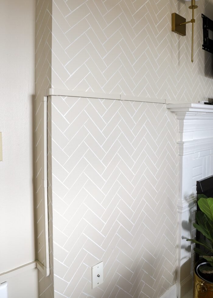 Cord concealer track along wall next to mantel and around corner
