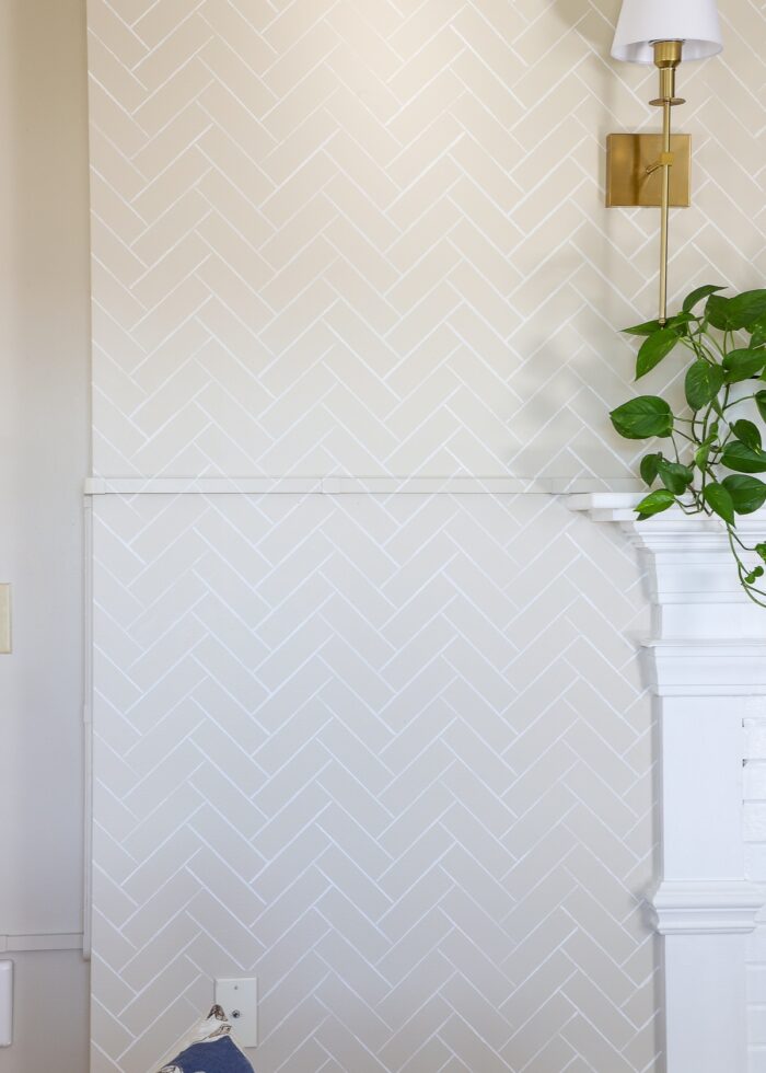 Beige wall with white herringbone tile pattern stenciled in white
