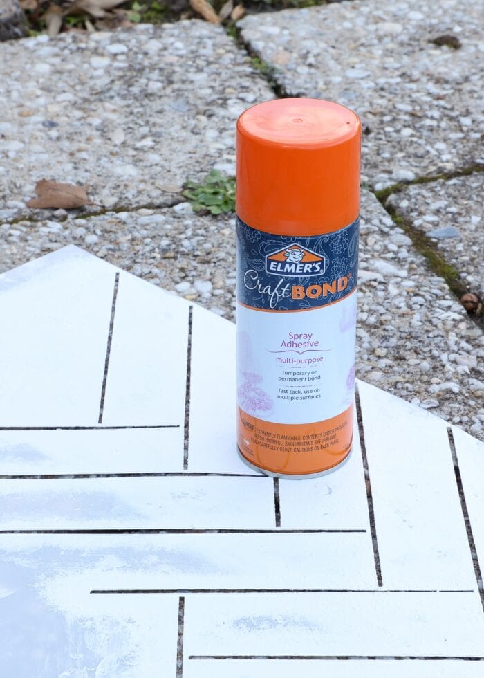 Wall stencil shown with a can of spray adhesive
