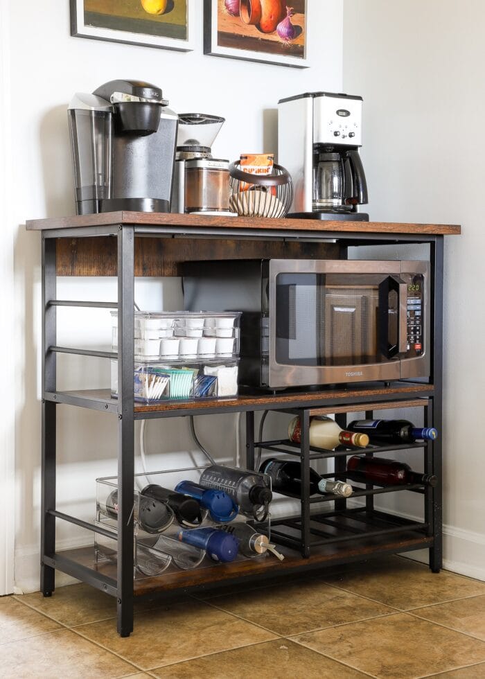 Kitchen coffee station loaded up with various organizes for bottles, spirits, coffee, tea and more!