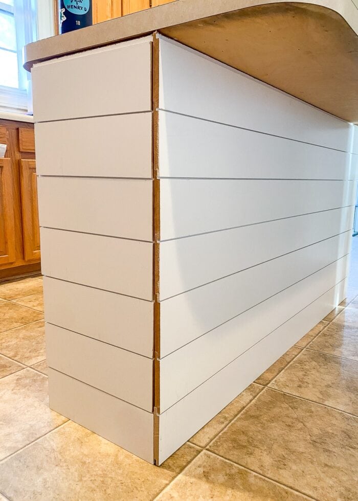 White shiplap on a kitchen island with unfinished corners