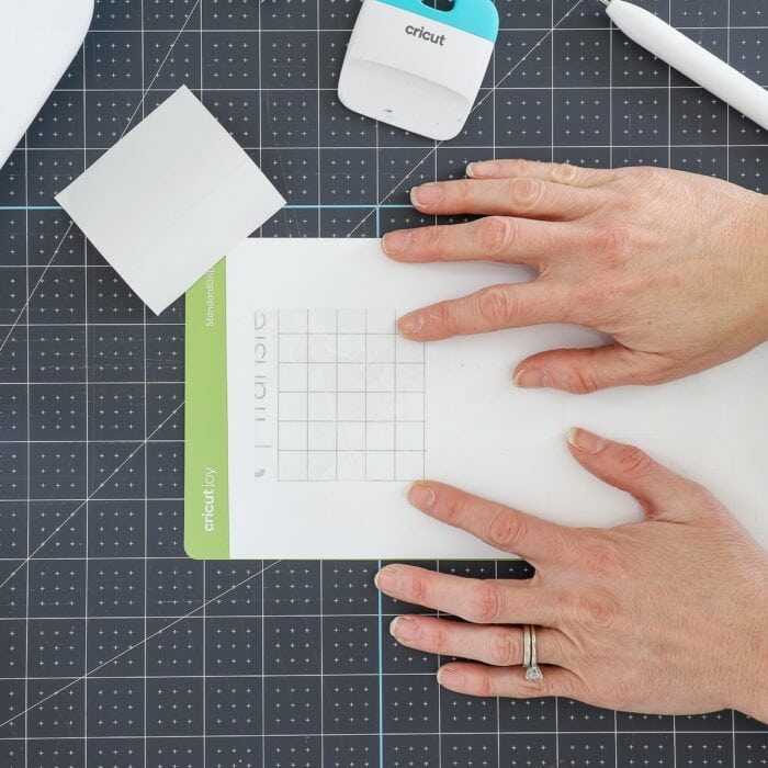 Hands placing transfer tape onto vinyl picture label