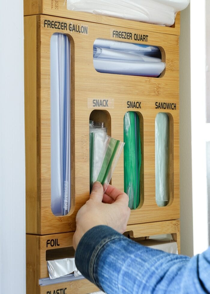 Hand pulling out a snack Ziplock bag from a hanging organizer