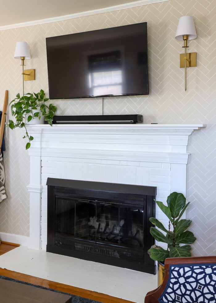 White painted mantel and brick around a rental fireplace