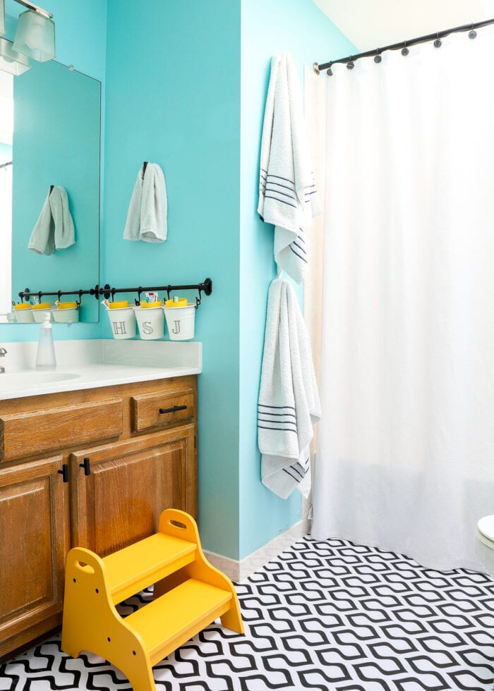 Turquoise, black, white, and yellow kids bathroom