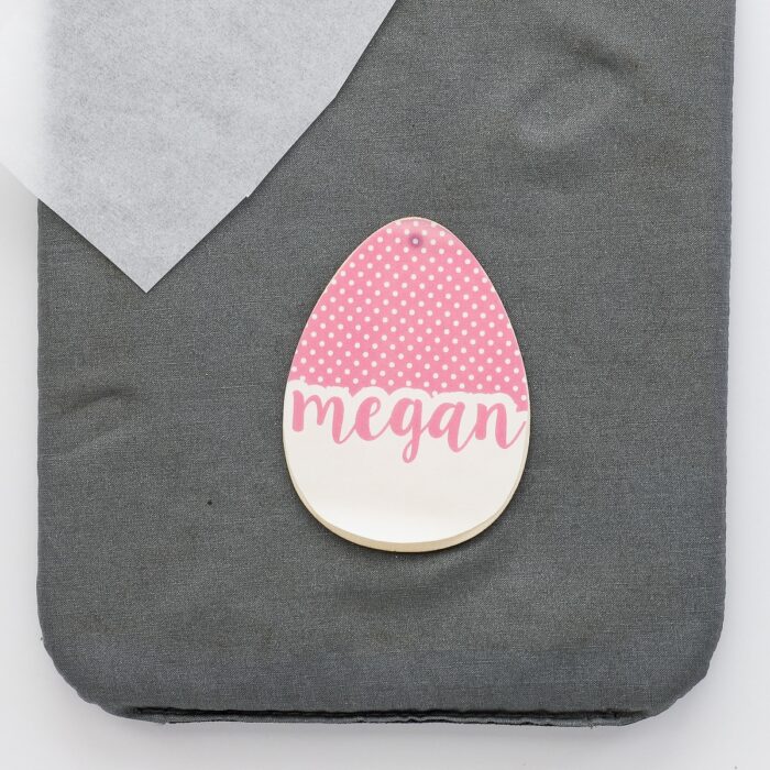 Personalized tag design on top of wooden egg cutout