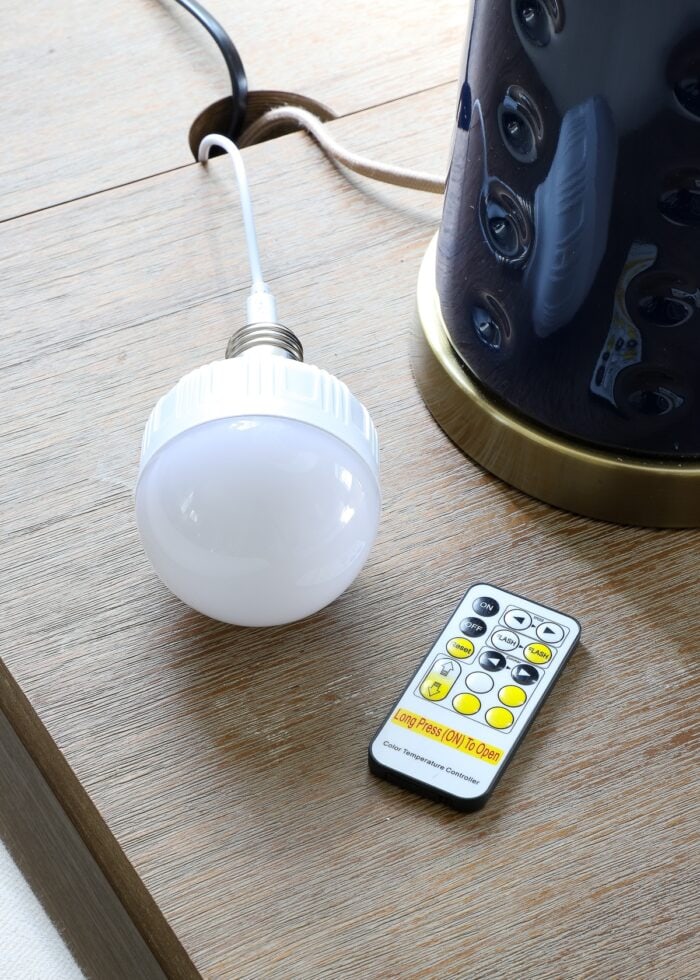 Chargeable lightbulb being charged next to remote