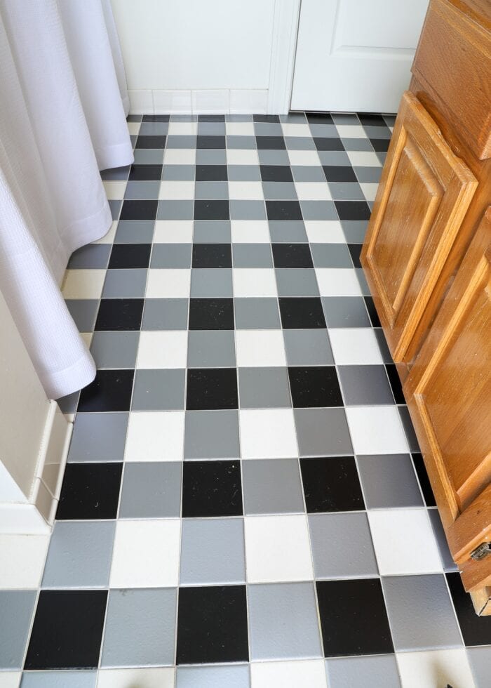 Black and white buffalo plaid tile floors made with bathroom tile stickers