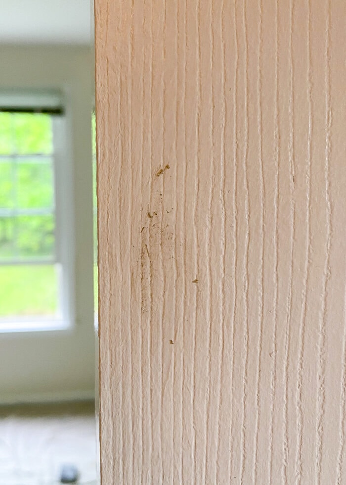 Remove glue left behind from adhesive hook on a painted door