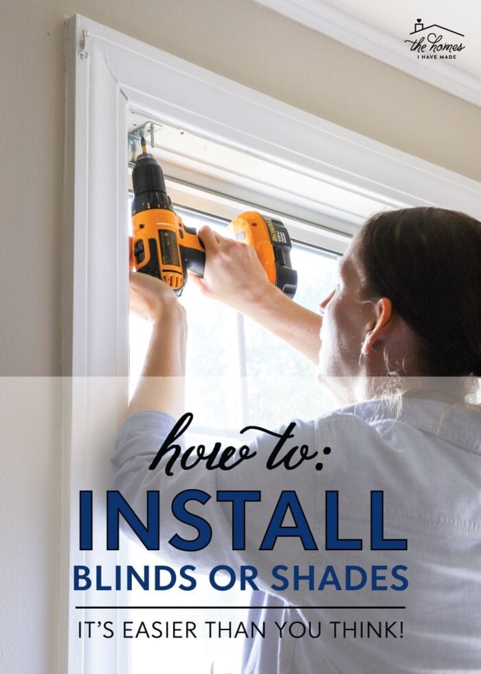 Megan using a drill inside a window frame to install cordless blinds