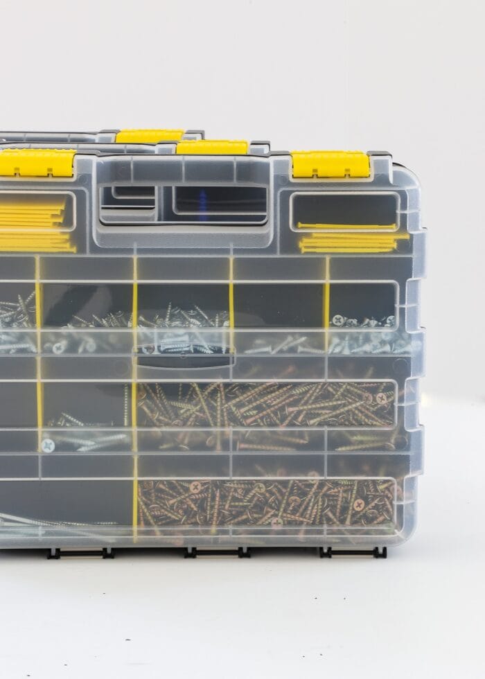 Compartmentalized storage box holding various sets of nails and screws