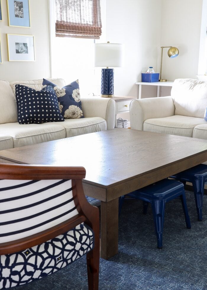 Navy and white family room with very large wooden coffee table