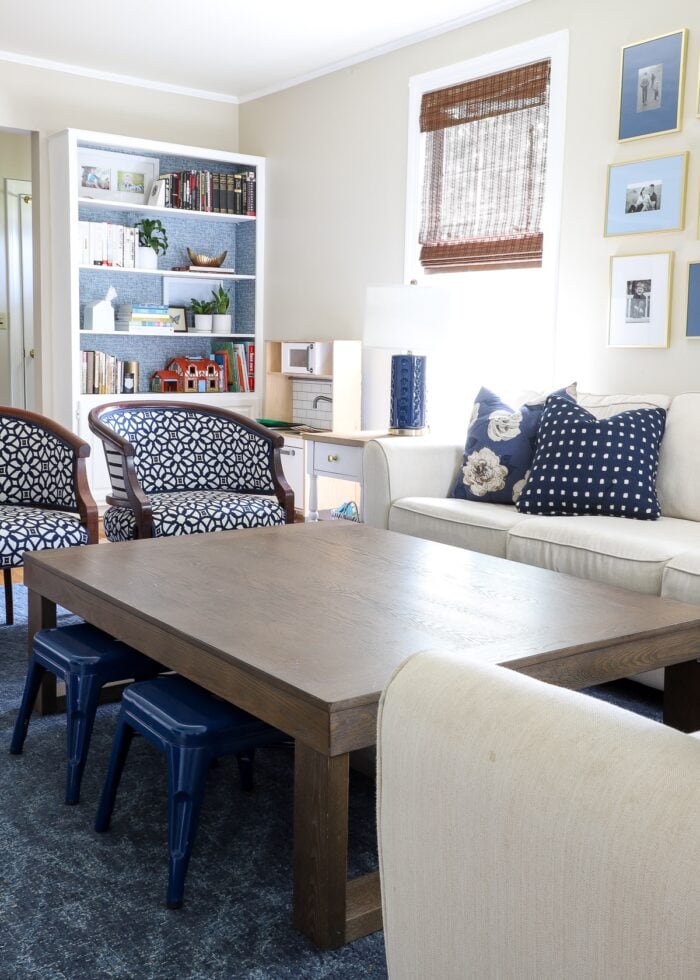 Navy and white living room with large brown coffee table