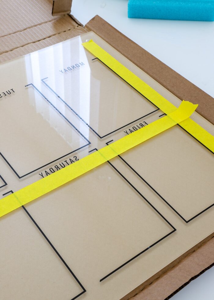 Yellow tape lines on an acrylic calendar board