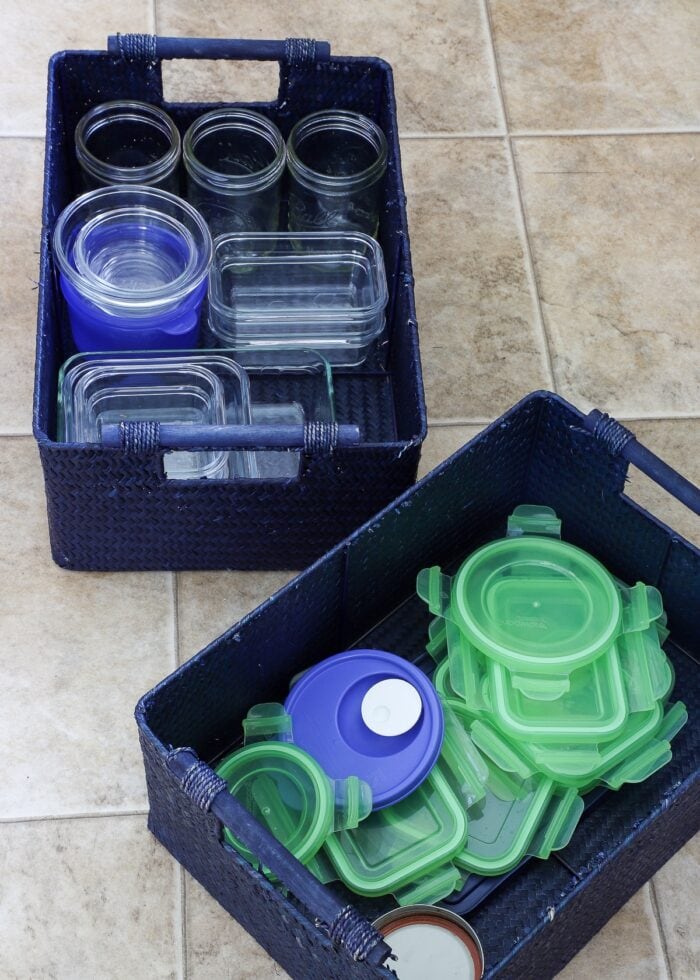 Organized food storage containers in blue baskets