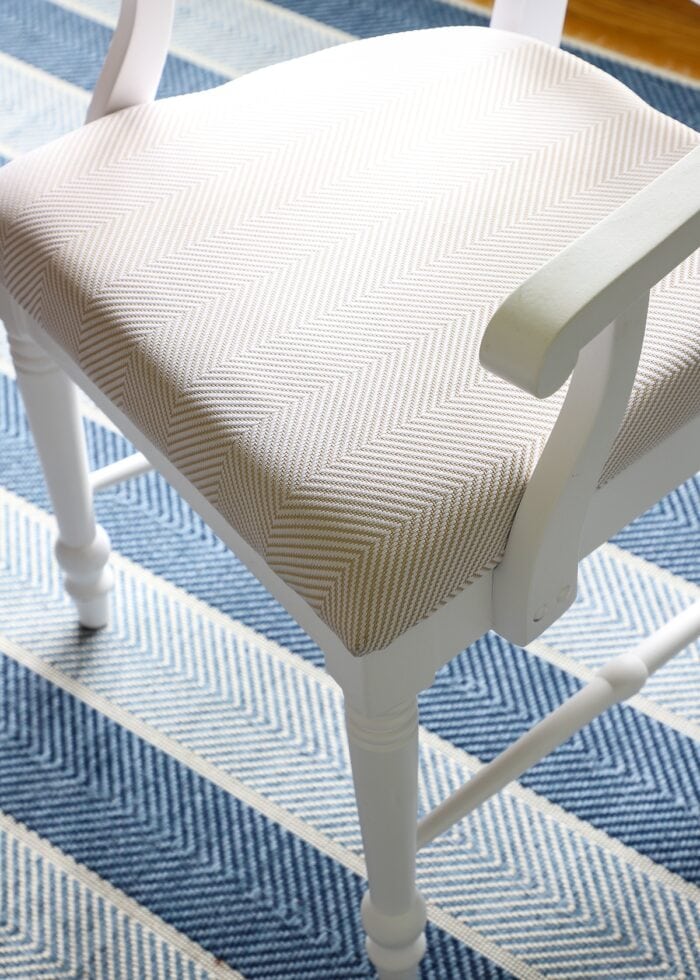 Close up of white and tan chevron fabric on dining chair seat