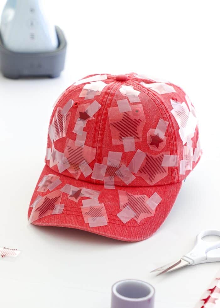 Red iron-on stars taped all over a red baseball cap