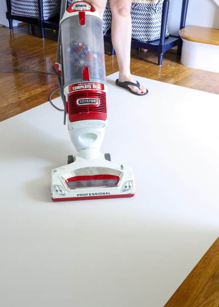 Vacuuming the back of a vinyl floor mat