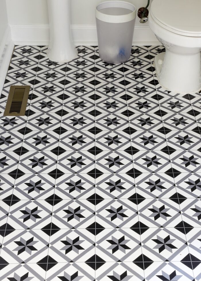 Black and white vinyl floor mat on a bathroom floor
