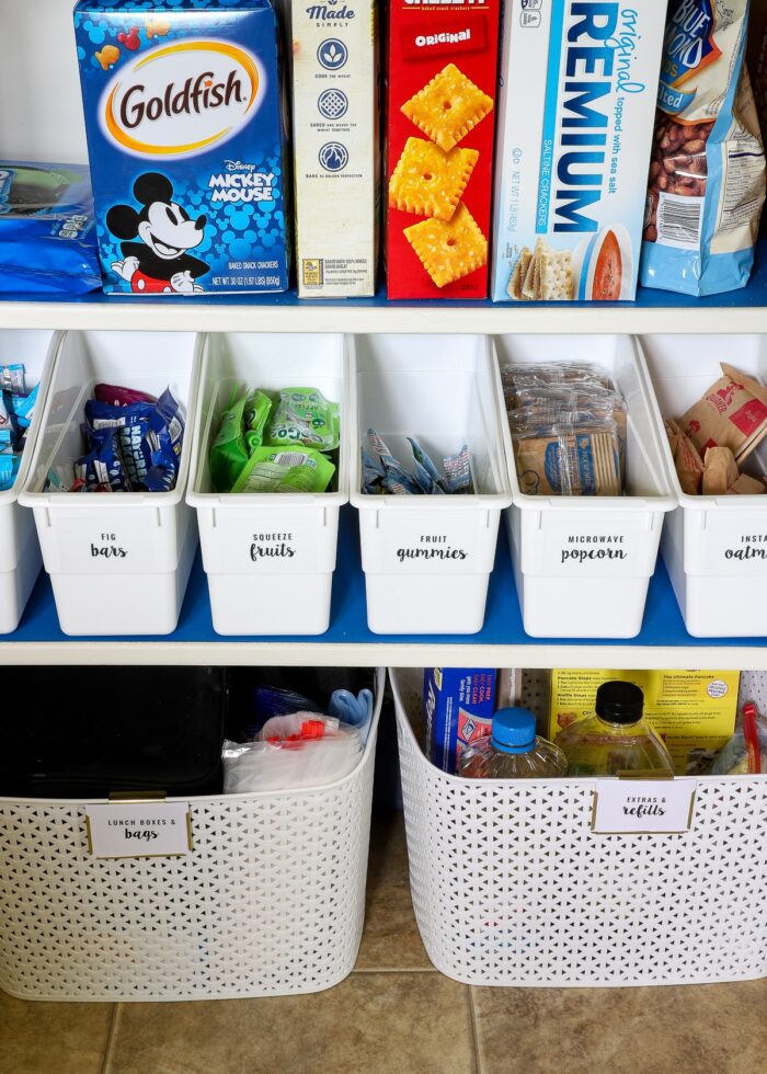 White book bins used to organize snacks in a pantry